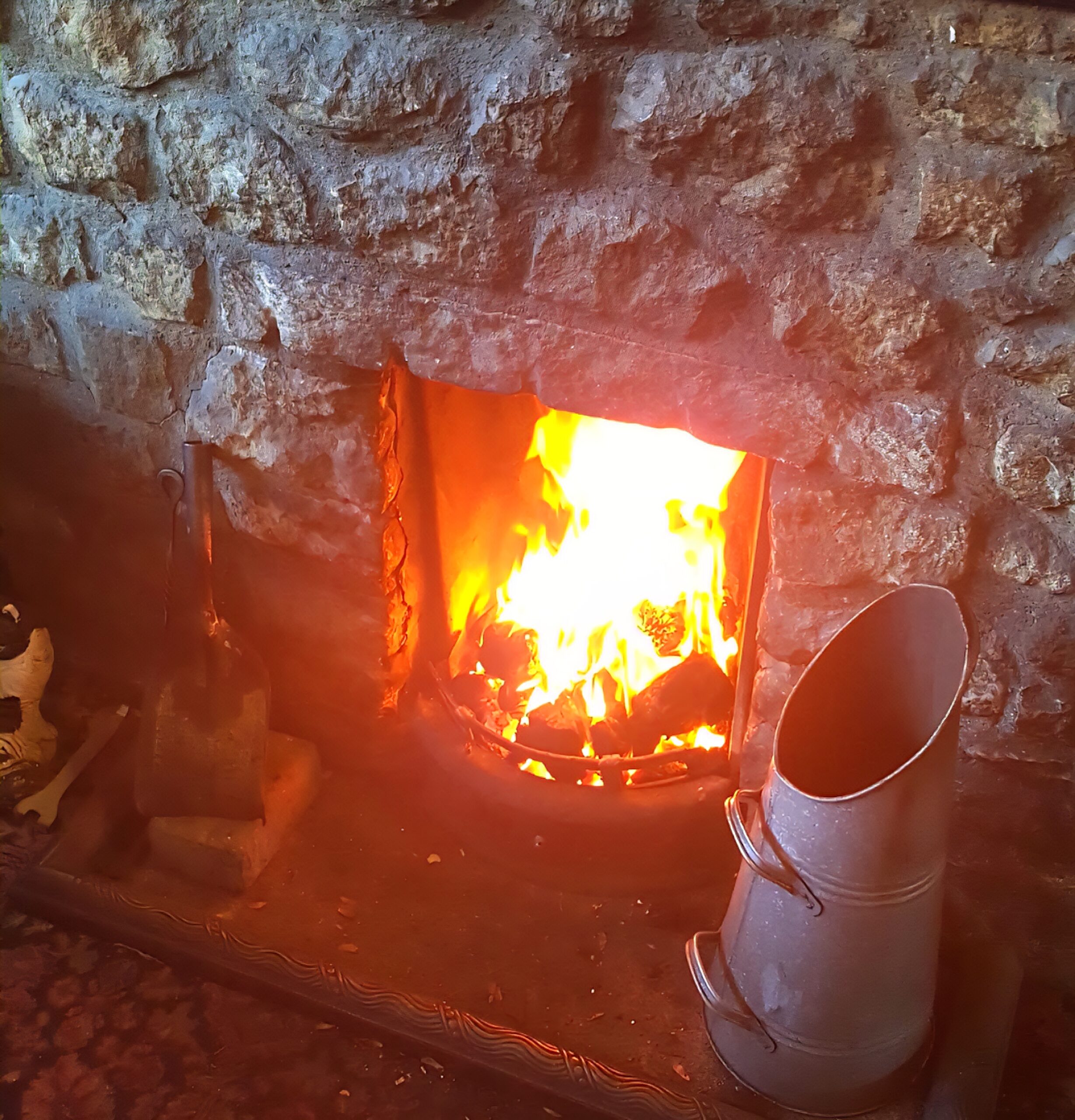 Real coal fire at the Swan Inn Abbotsbury keeping visitors warm and dry on a wet Good Friday